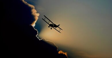 Speed of time: A light single-engine plane gliding above a mass of dark clouds.